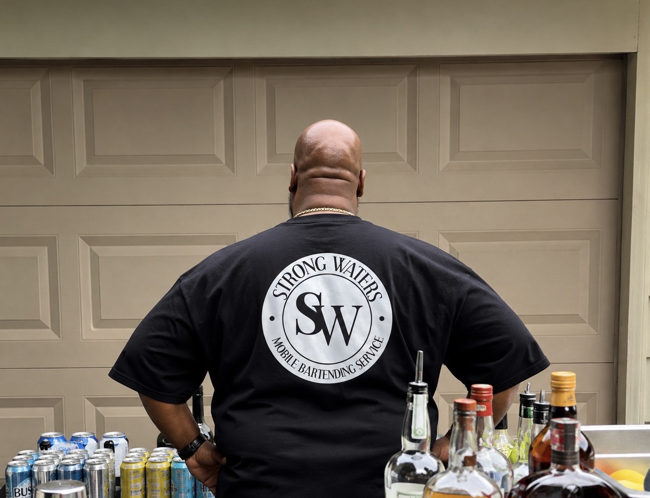 Back of Strong Waters Bartending shirt at an event